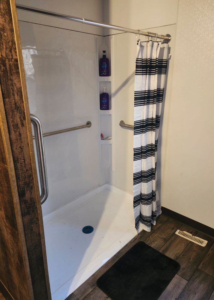The Dillons' family bathroom, with a roll-in shower, a lowered countertop and accessible toilet. Renovated by Solid Value Contracting with additional funding from the Bothwell ToRCH program.