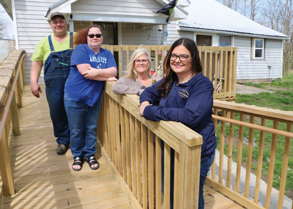 Kevin and Miranda Dillon, left, stand on the deck and ramp built for their son Adam Larsson at their home, along with Elizabeth Green, Bothwell ToRCH program manager, and Traci Miller, Solid Value Contracting general manager.