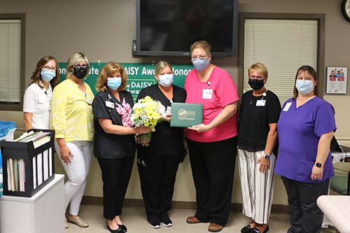 Bothwell staff presenting nurse Sarah Fredrickson with the coveted DAISY award