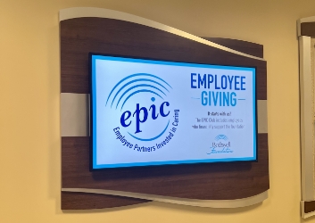 One of the TVs on the donor wall showing the Employee Giving slide