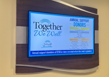 One of the TVs on the donor wall showing the Annual Support Donors slide