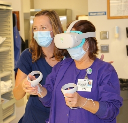 Two health care workers using a virtual reality headset