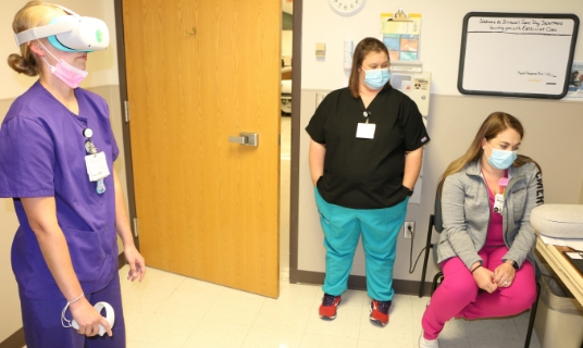 Ashley Schroder, left, a registered nurse in Bothwell’s Post-Anesthesia Care Unit, works through a VR simulation on malignant hyperthermia while Kim Perez, Clinical Education director and Megan Elwood, Nursing Education educator watch.