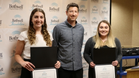 Kevin Almquist, center, presented the Nevin Almquist Physical Therapy Scholarship to first recipients Courtney Koetting, left, and Addyson Wright.