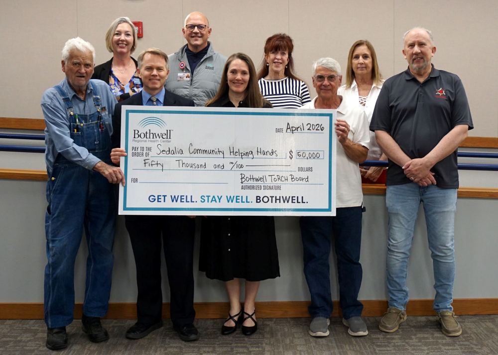 Sedalia Community Helping Hands (SCHH) volunteers, pictured with a $50,000 grant awarded by the ToRCH Be Well Leadership Board.