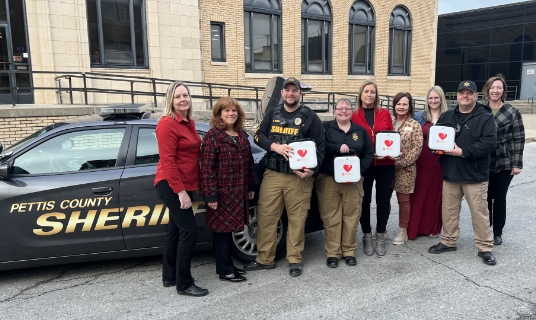 From left to right: Dianne Simon and Lori Wightman, Wear Red for Women committee co-chairs; PCSD Sergeant Scott DeHaven; PCSD Sergeant Heather Hawkins-Hoehne; Robin Balke and Trish Henson, committee members; Lauren Thiel-Payne, Bothwell Foundation executive director; PCSD Captain of Operations Mike Simons; and Allison Brosch, committee member.