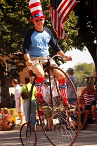 Dr. Kiburz riding an 1880 high wheel bike