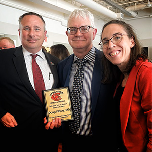 Dr. Douglas Kiburz was recognized by the University of Central Missouri Athletic Training program with the Bob and Sandy Russell Service Award on Friday, April 21. From left, Dr. Brian Hughes, Athletic Training program director and professor; Kiburz; and Dr. Molly Cuffe, assistant professor.