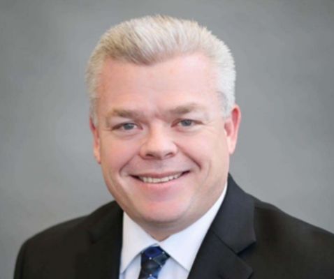 A professional headshot of Mike Harvey
