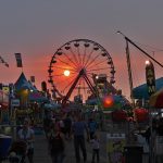 Attendees at the Missouri State Fair at dusk