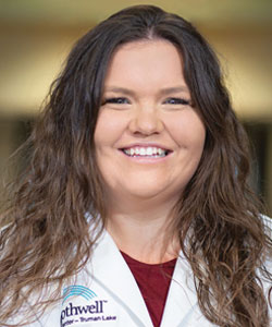 Chelsea Casteel, FNP wearing a red shirt and white Bothwell white coat